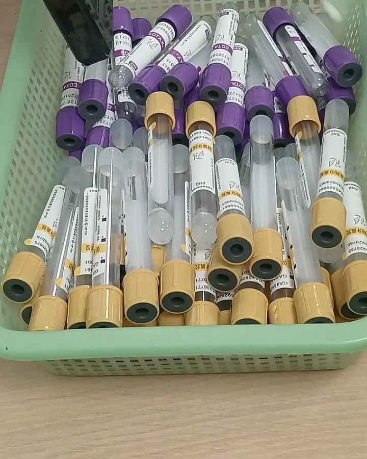 A basket of lavender-top and gold-top blood collection tubes